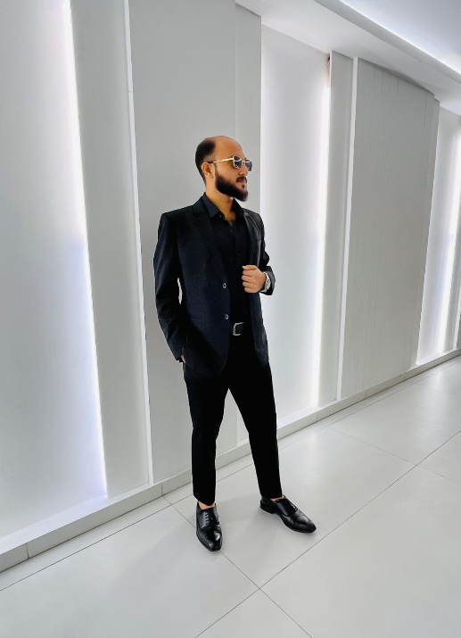 Ahtesham Sajid standing in a suit